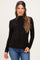 woman wearing a black floral long sleeve maternity top with a high neckline and holding her baby bump