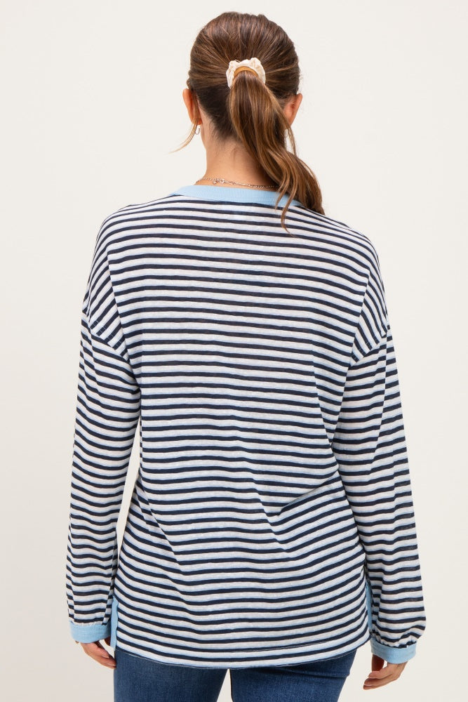 woman wearing a blue and white striped long sleeve maternity top, back view