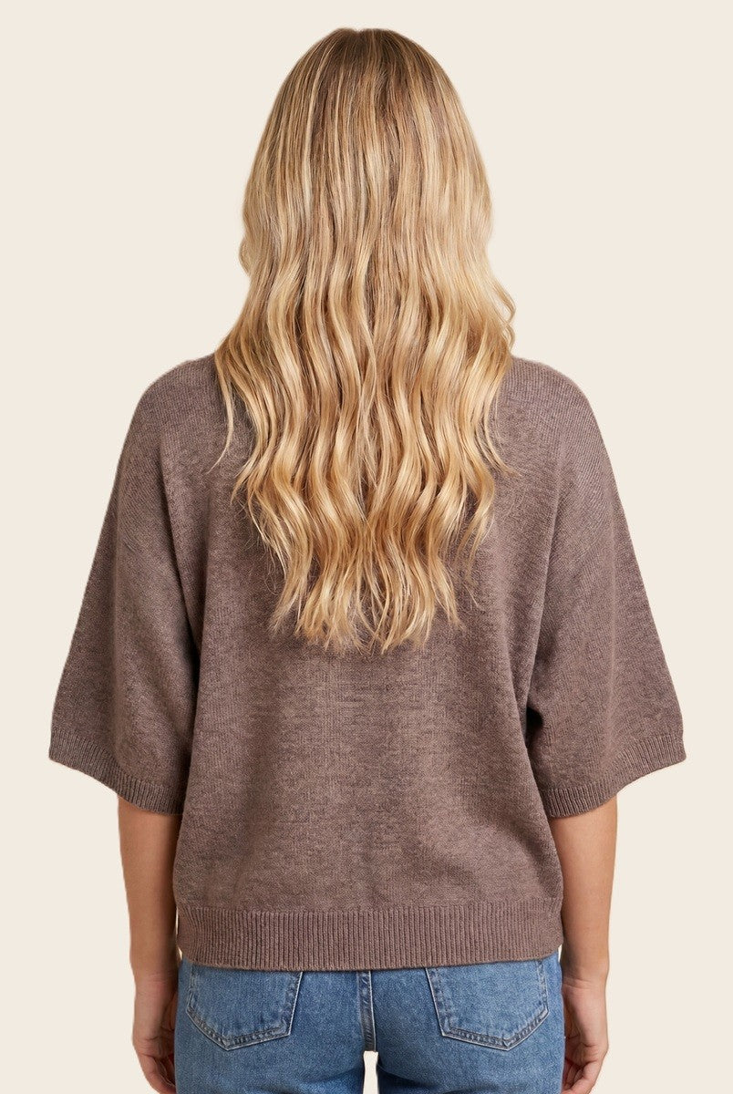 woman wearing a brown oversized sweater with short sleeves, seen from the back