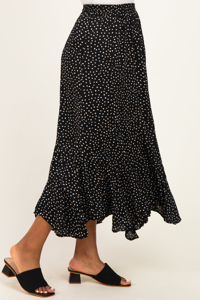 woman wearing a black polka dot tiered midi skirt and black open-toe block heel mules