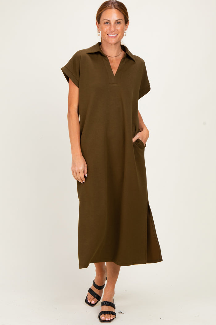 woman wearing an olive green short sleeve maxi dress with a collar and side pockets