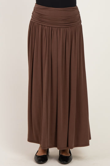 woman wearing a brown maxi skirt with a gathered waistband and flowing silhouette