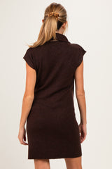 woman wearing a dark brown maternity sweater dress with short sleeves and a relaxed fit, showing the back view