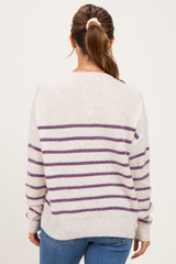 woman wearing a striped cream and purple maternity sweater, shown from the back with a relaxed fit
