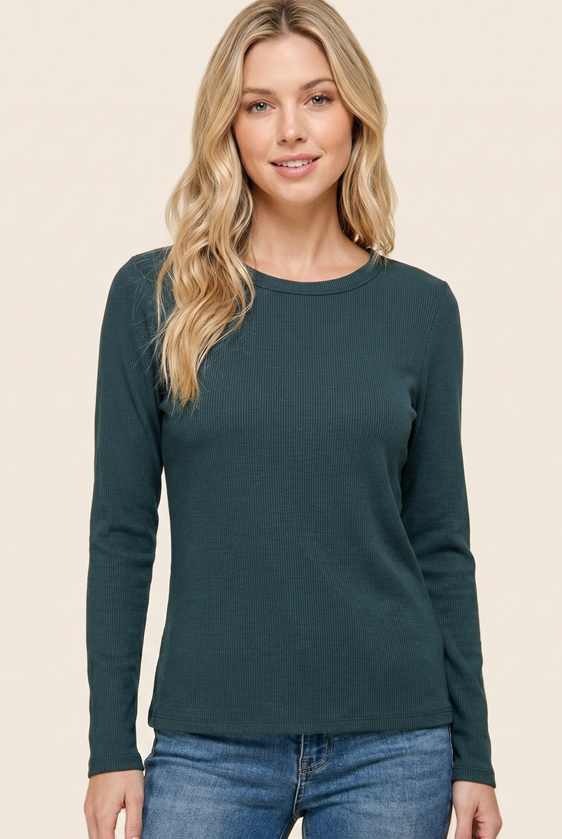 woman wearing a dark teal long sleeve ribbed top with a rounded neckline and relaxed fit