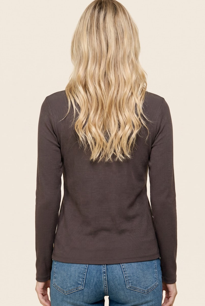 woman wearing a dark brown long sleeve ribbed top, seen from the back, paired with light wash jeans