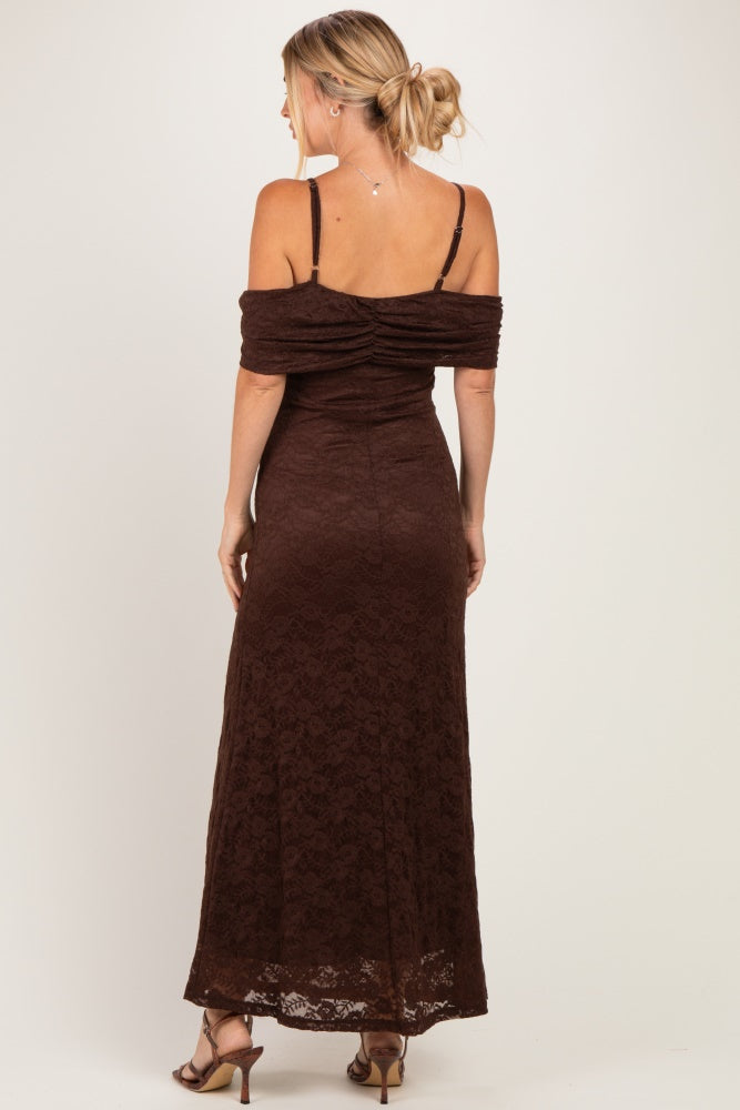 woman wearing a brown lace maxi dress with off-the-shoulder sleeves and back ruching, styled with a hair bun
