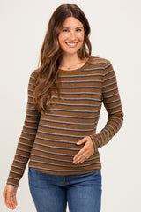 woman wearing a brown and gray striped maternity top with long sleeves and holding her baby bump