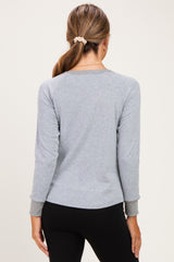 woman wearing a gray long sleeve maternity top with a relaxed fit, shown from the back