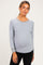 woman wearing a gray maternity sweatshirt with raglan sleeves and a visible baby bump