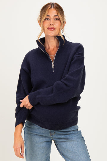 woman wearing a navy blue zip-up maternity sweater with a relaxed fit and a high collar
