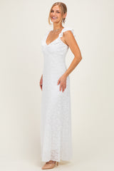woman wearing a white lace maxi dress with ruffled sleeves and a deep v-neckline
