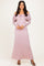 woman wearing a light pink off-the-shoulder lace maxi dress with long sleeves and a tie-front detail