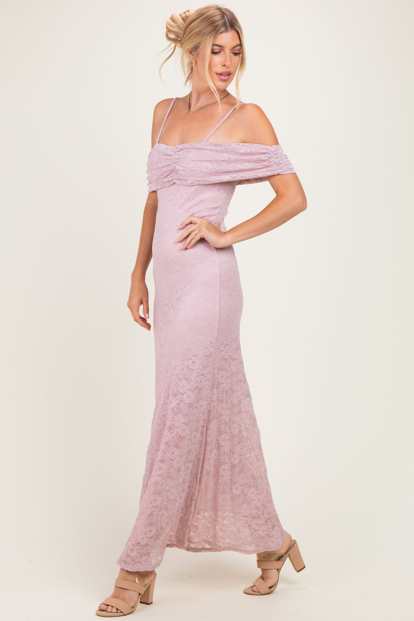 woman wearing a lilac off-the-shoulder lace maxi dress with a ruched bodice and a flared skirt