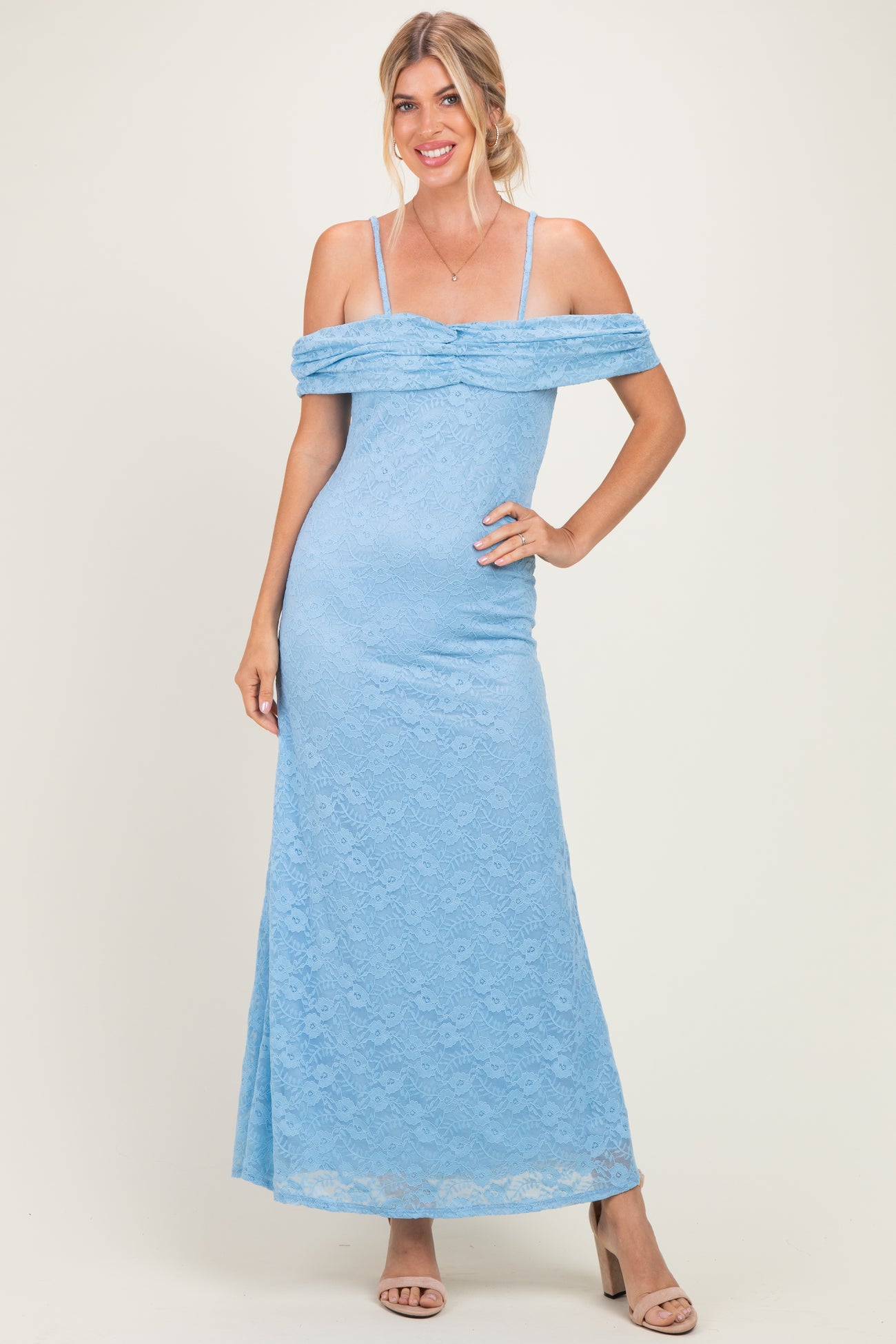 woman wearing a light blue off-the-shoulder lace maxi dress with a fitted silhouette and spaghetti straps