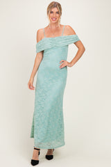 woman wearing a mint green off-the-shoulder lace maxi dress with fitted silhouette and spaghetti straps