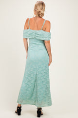 woman wearing a mint green off-the-shoulder lace maxi dress with ruched detailing on the back