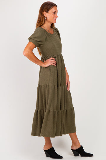 woman wearing an olive green tiered maxi dress with short sleeves and a relaxed fit