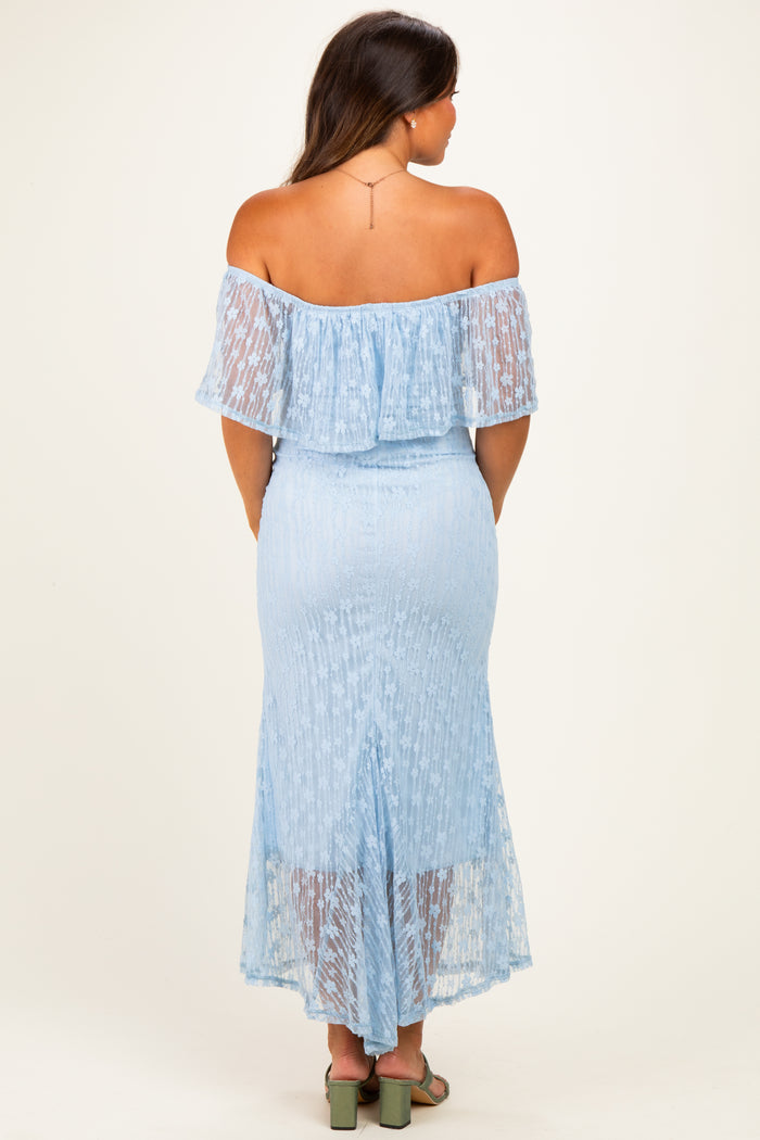 woman wearing a light blue off-the-shoulder maternity dress with a ruffled hem and a fitted silhouette, showcasing a baby bump from the back