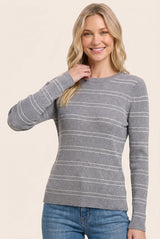 woman wearing a gray long sleeve striped sweater with ribbed texture and a relaxed fit