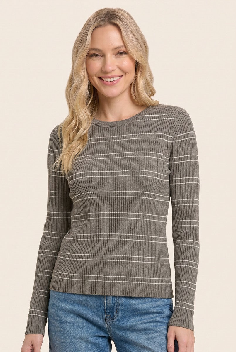 woman wearing a gray ribbed long sleeve top with white stripes and smiling
