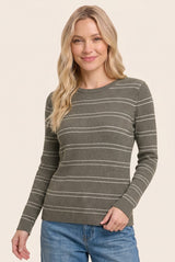 woman wearing an olive green ribbed long sleeve top with white stripes and smiling