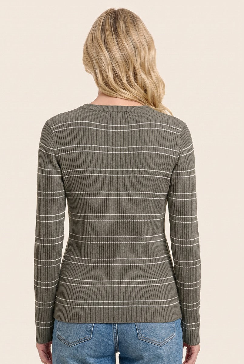 woman wearing a green ribbed long sleeve top with white stripes, seen from the back