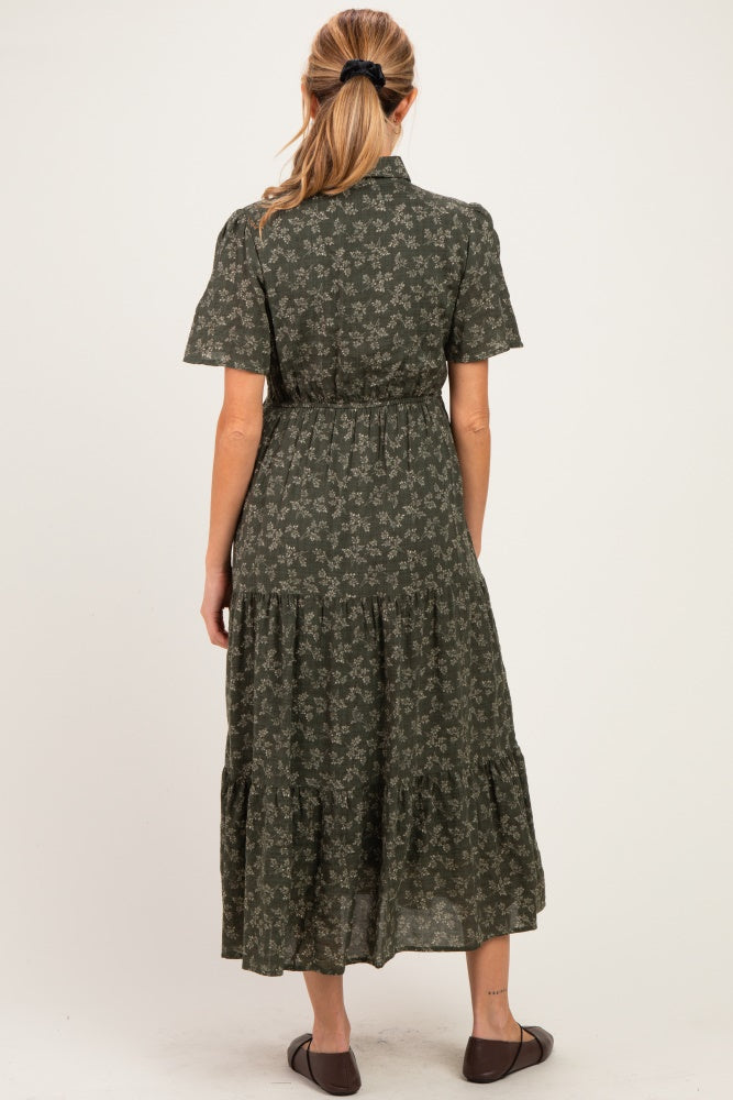 woman wearing a green floral maternity dress with short sleeves and a tiered skirt, showing a baby bump from the back