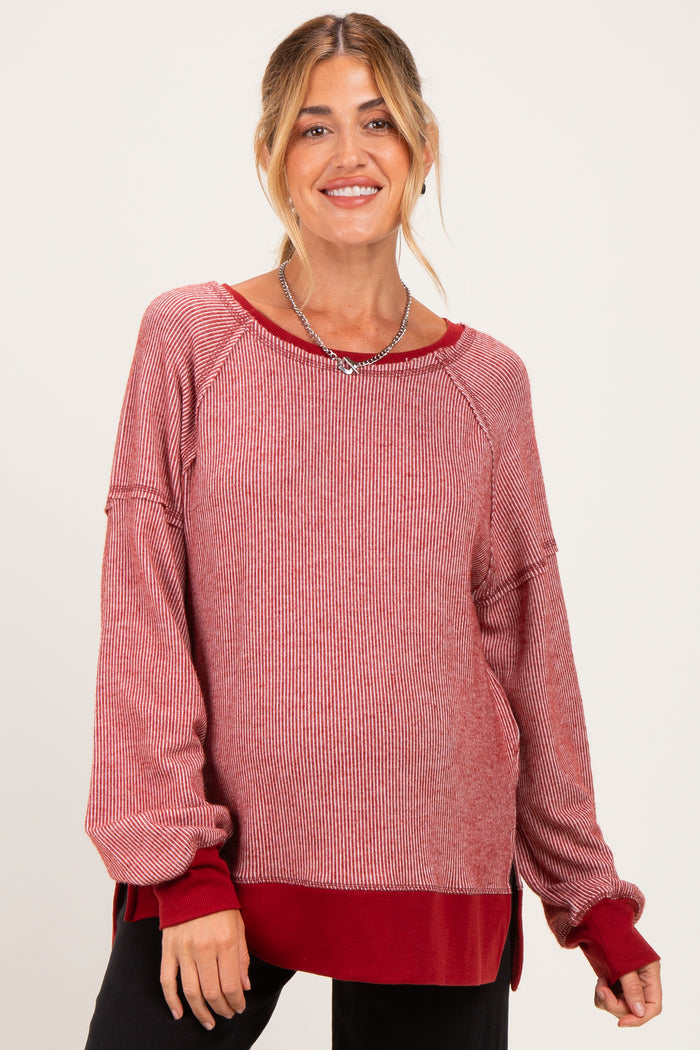 woman wearing a red and white striped long sleeve maternity top with a relaxed fit and side slits