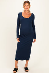 woman wearing a navy long sleeve ribbed maternity dress and showing her baby bump
