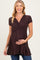 woman wearing a chocolate brown short sleeve maternity dress with a crossover bodice and baby bump visible
