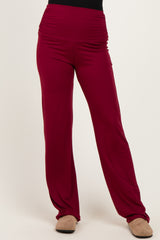 woman wearing maroon wide-leg pants with a high waistband and ruching details