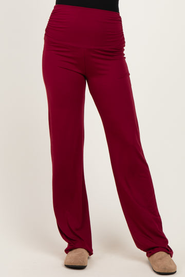 woman wearing maroon wide-leg pants with a high waistband and ruching details