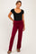 woman wearing a black scoop neck bodysuit and burgundy maternity pants with a ruched waistband