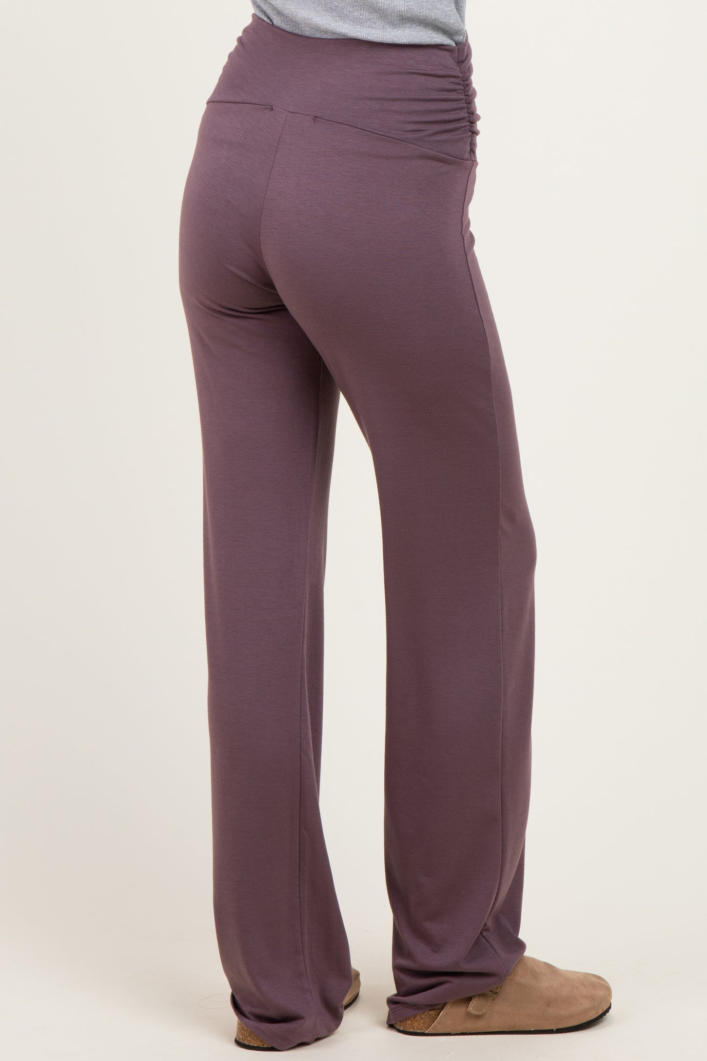 woman wearing purple ruched waistband pants viewed from the back
