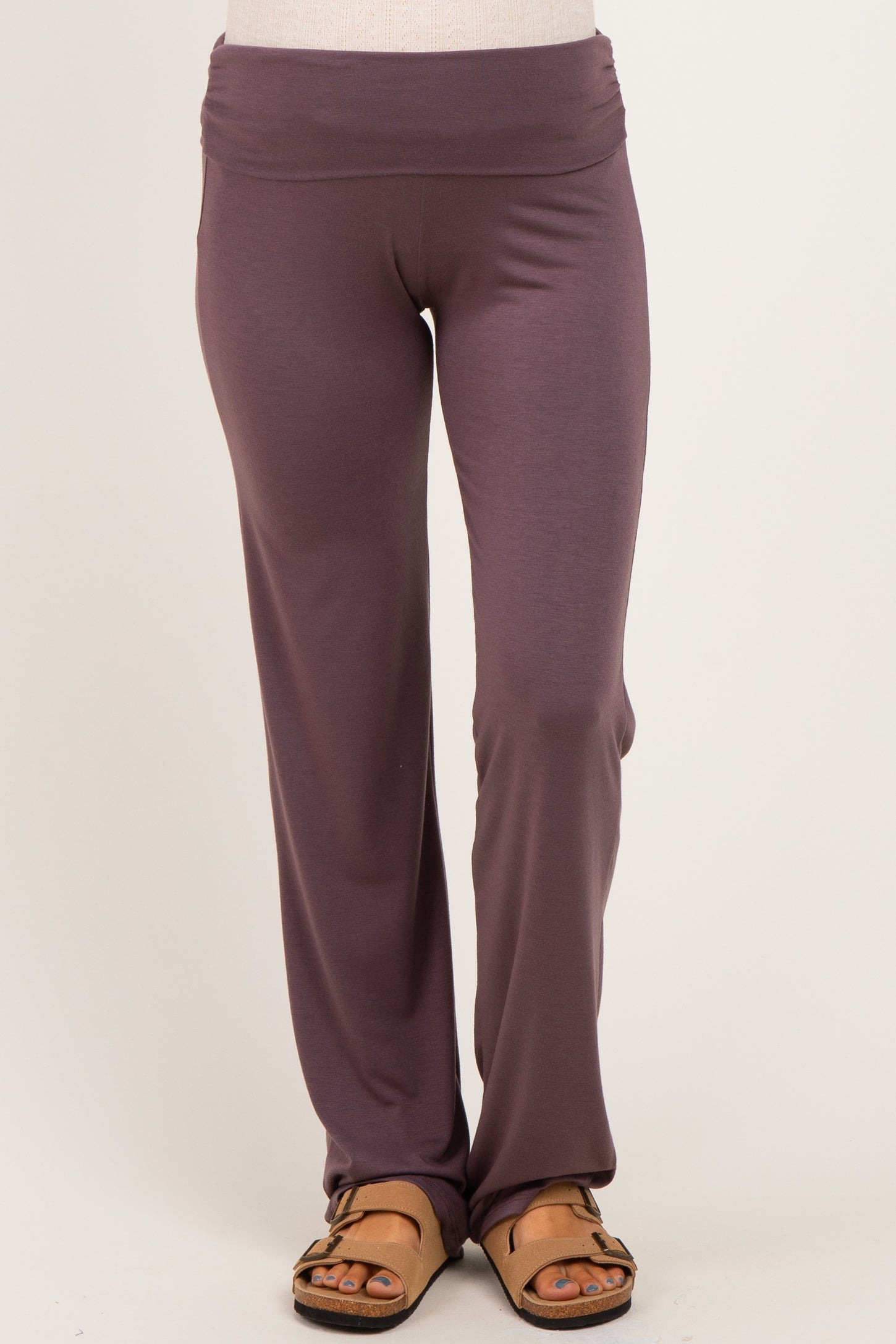 woman wearing purple maternity pants with a wide waistband and a relaxed fit