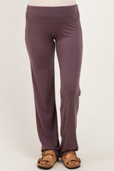 woman wearing purple maternity pants with a wide waistband and a relaxed fit