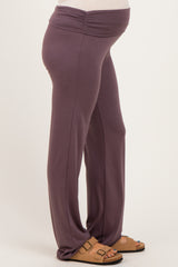 woman wearing purple maternity pants with a gathered waistband and visible baby bump