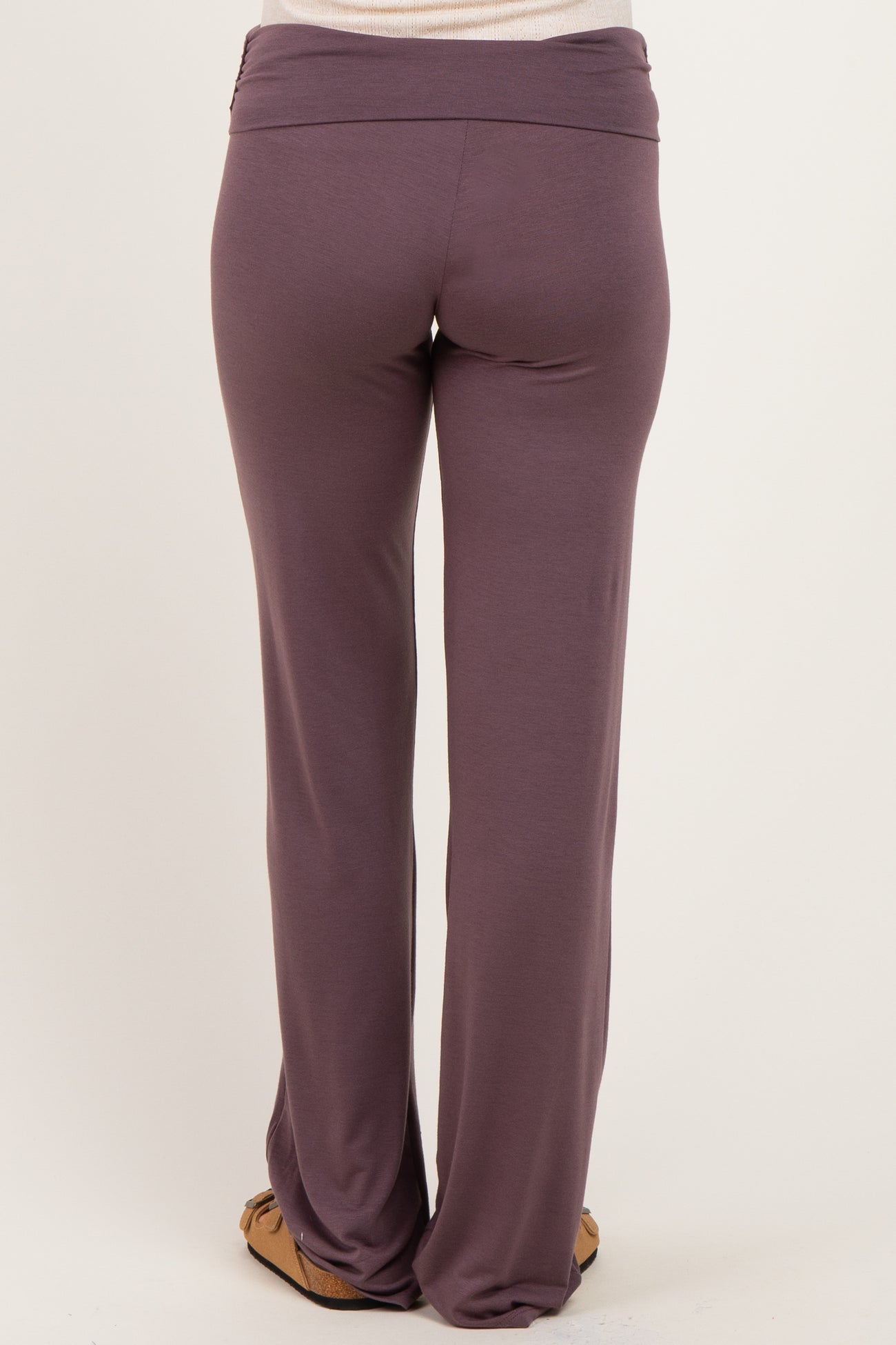 woman wearing purple maternity pants, shown from the back, with a soft waistband and relaxed fit