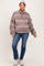 woman wearing a patterned fleece maternity pullover and blue jeans with a baby bump visible