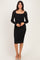 woman wearing a black lace long sleeve midi dress with a square neckline and form-fitting silhouette