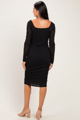 woman wearing a black lace midi dress with long sleeves, showing a fitted silhouette and square neckline