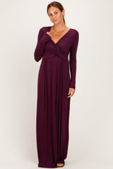 woman wearing a long sleeve deep plum maxi dress with a twisted front detail and a flattering silhouette