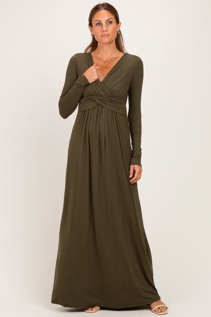 woman wearing an olive green long sleeve maxi dress with a wrapped bodice and pleated skirt