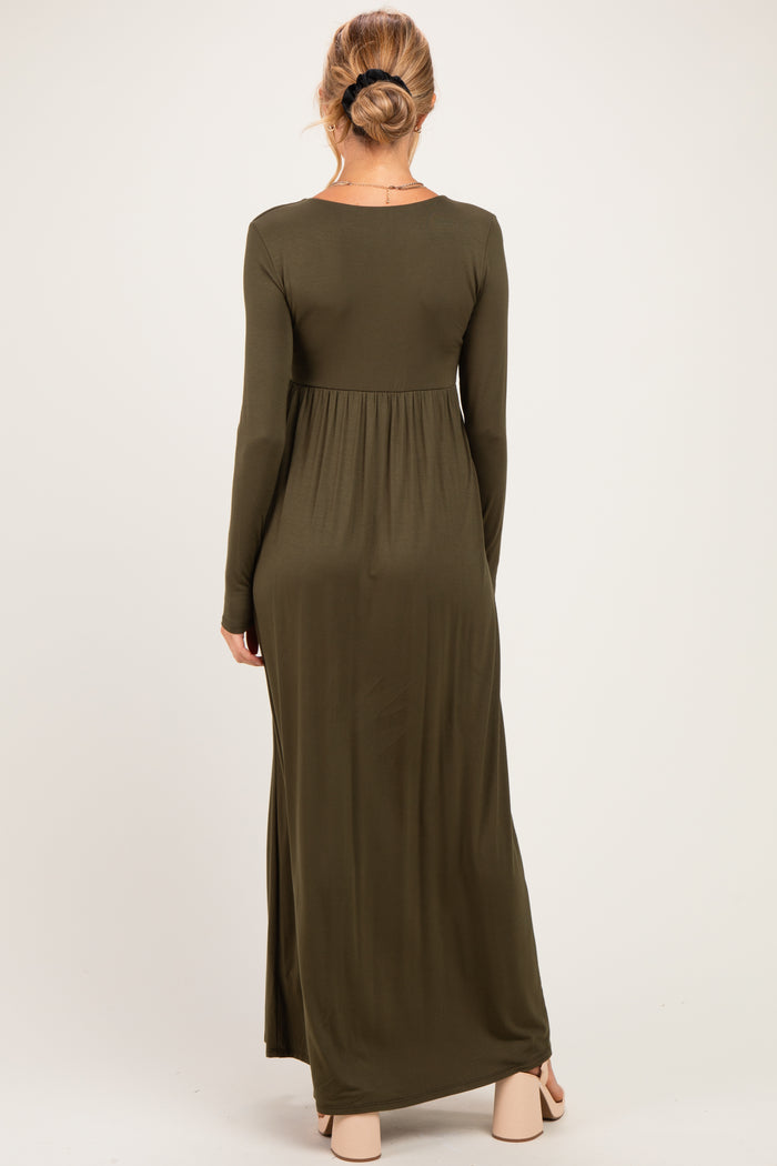 woman wearing an olive green long sleeve maternity maxi dress, back view, with a fitted bodice and flowing skirt