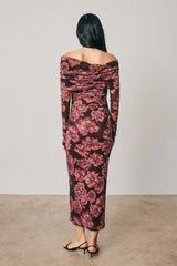 woman wearing a long sleeve off-the-shoulder floral print midi dress in burgundy and pink