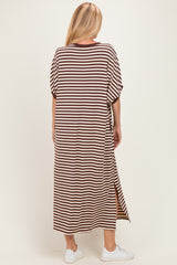 woman wearing a brown and cream striped maxi dress with short sleeves and side slits, view from the back