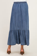 woman wearing a denim maxi skirt with a tiered ruffle hem in a maternity style