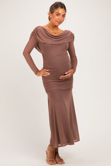 woman wearing a brown long sleeve maternity dress with ruching and a draped neckline, holding her baby bump