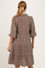 woman wearing a brown floral short sleeve maternity dress with tiered skirt and back button detail